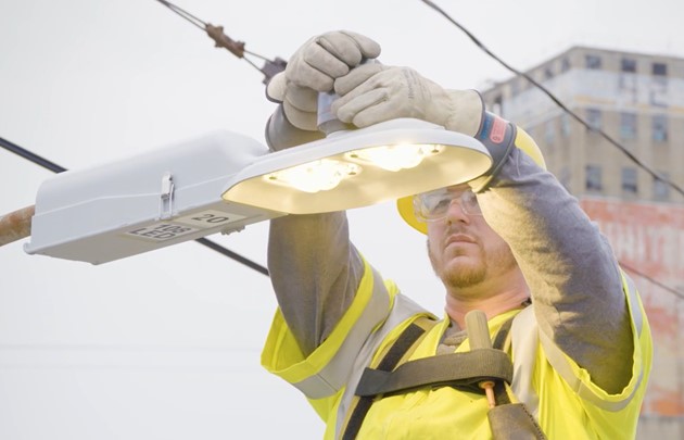 A man working on street lights.